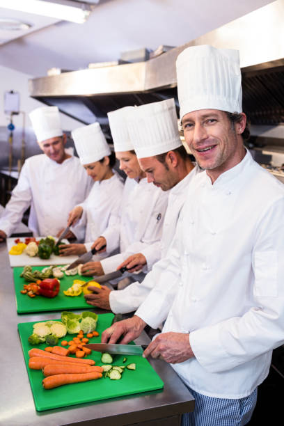 istock Team of chefs chopping vegetables 698540522