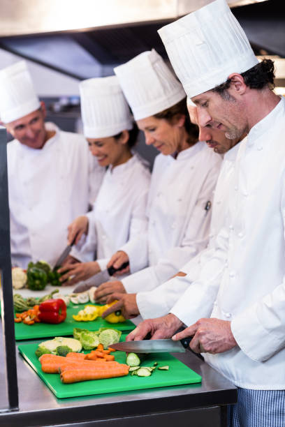 istock Team of chefs chopping vegetables 698540606