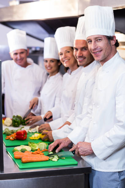 istock Team of chefs chopping vegetables 698540680