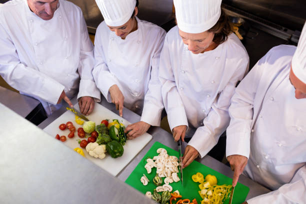 istock Team of chefs chopping vegetables 698540854