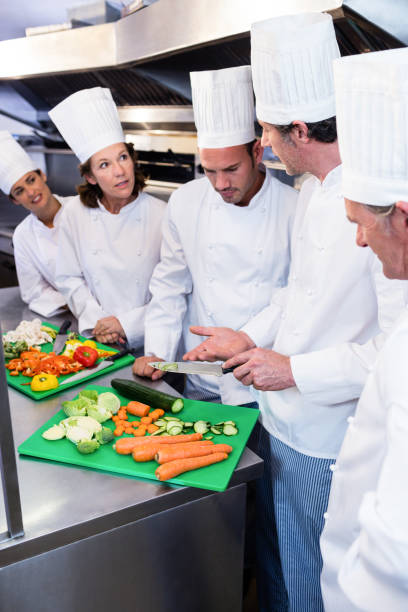istock Team of chefs chopping vegetables 698541108