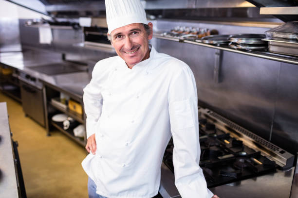 istock Happy male chef standing in commercial kitchen 698541758