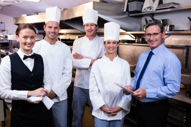 istock Happy restaurant team standing together in commercial kitchen 698541946