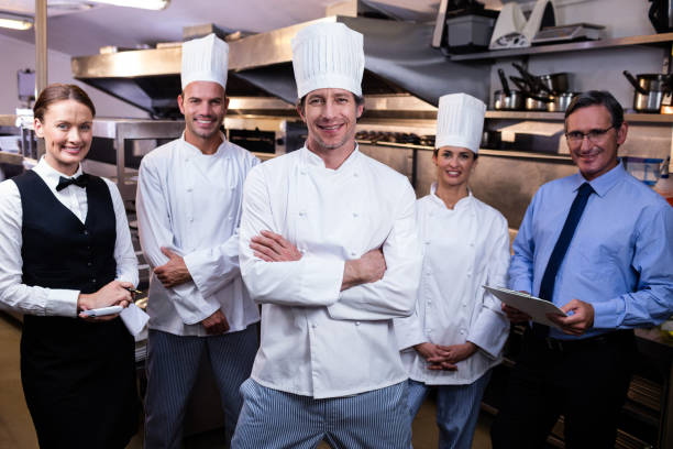 istock Happy restaurant team standing together in commercial kitchen 698542018