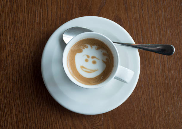 istock Cup of coffee with face in crema. 698556420