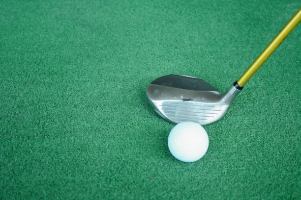 Golf clubs and golf balls on green artificial grass At the golf driving range Golf clubs and golf balls on green artificial grass At the golf driving range artifical grass stock pictures, royalty-free photos & images