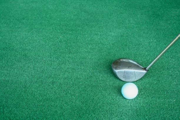 istock Golf clubs and golf balls on green artificial grass At the golf driving range 698557506