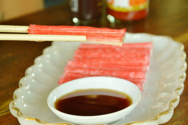 istock imitation crab stick made from fish dipping with soy sauce 698563038