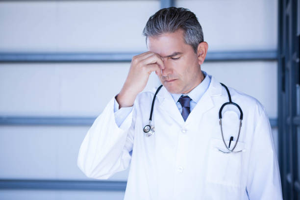 istock Tensed doctor standing in hospital 698564666