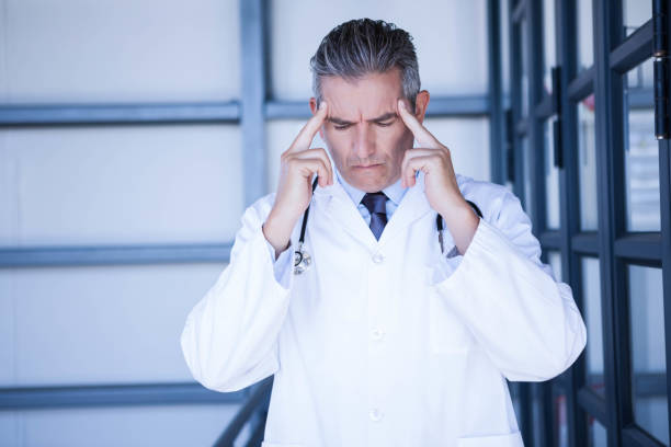 istock Thoughtful doctor standing in hospital 698564710