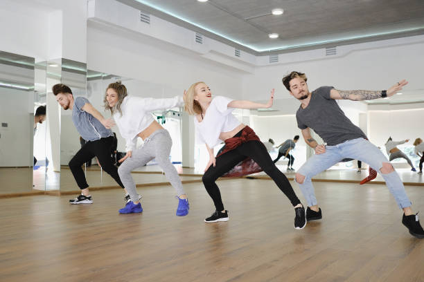 istock Group of young modern dancers dancing in the studio 698565472