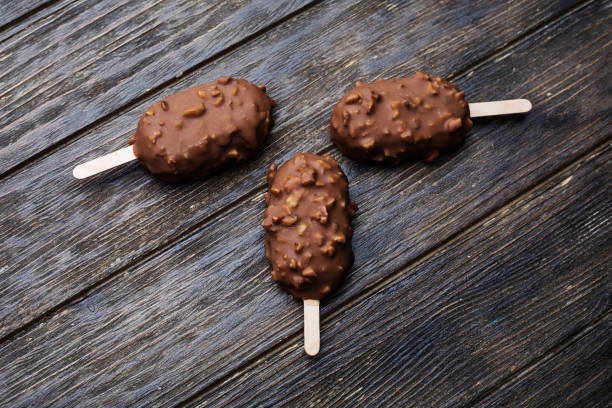 istock Ice cream in chocolate glaze in wooden background 698570816
