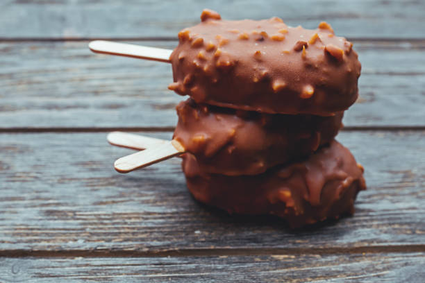 istock Ice cream in chocolate glaze in wooden background 698570828