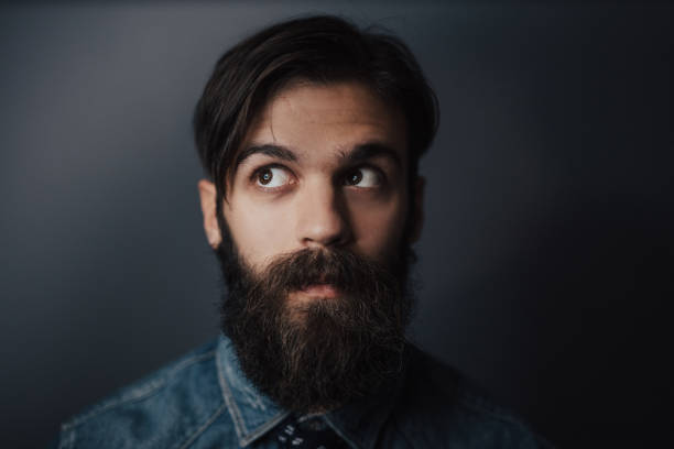 Close up of bearded man looking up