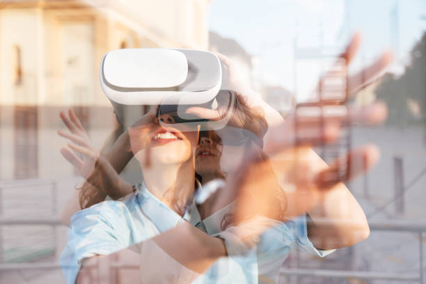 istock Double exposure of woman using the virtual reality headset 698582938