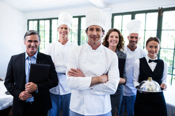 istock Happy restaurant team standing together in restaurant 698583222