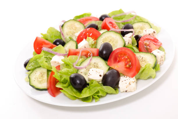 istock greek salad isolated on white background 698584198