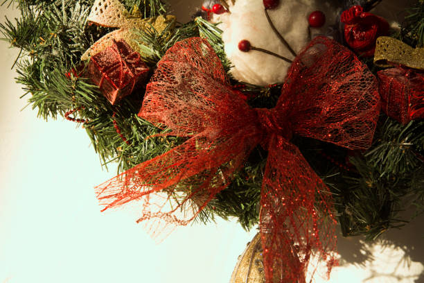 Close-up of a Christmas wreath Close-up of a Christmas wreath on the background of bright walls pine log state forest stock pictures, royalty-free photos & images