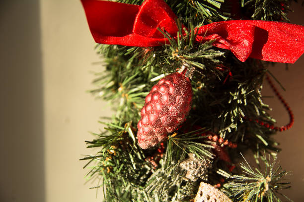 Close-up of a Christmas wreath Close-up of a Christmas wreath on the background of bright walls pine log state forest stock pictures, royalty-free photos & images