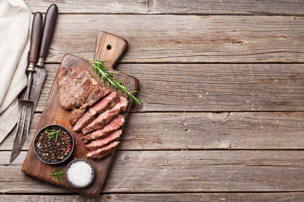 istock Grilled beef steak with spices on cutting board 698590040