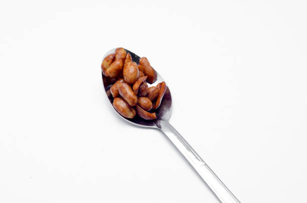 istock Delicious roasted nut in spoon on white background 698590068