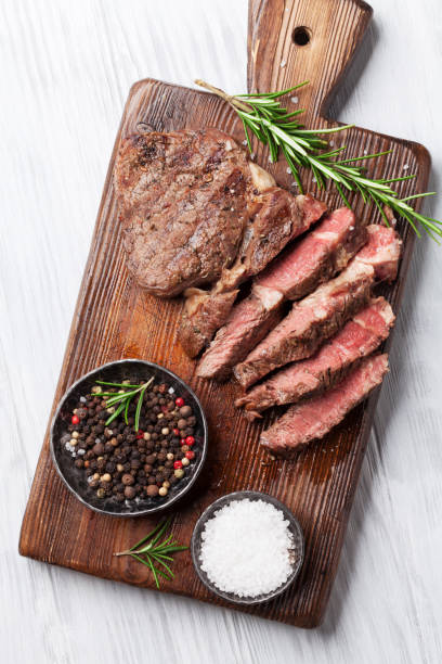 istock Grilled beef steak with spices on cutting board 698590158