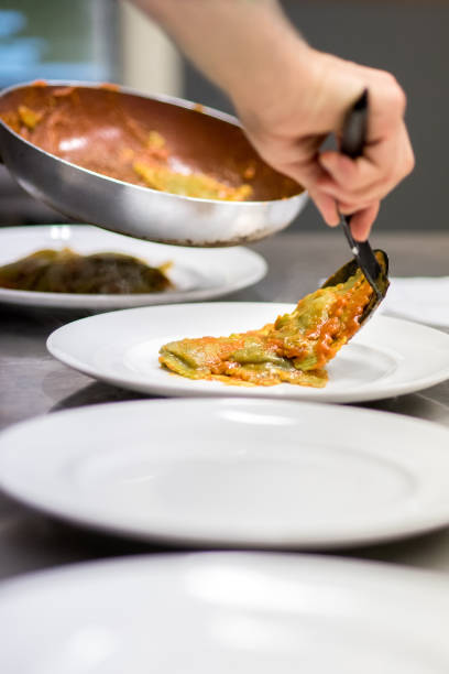istock Chef serving up Italian ravioli pasta 698591104