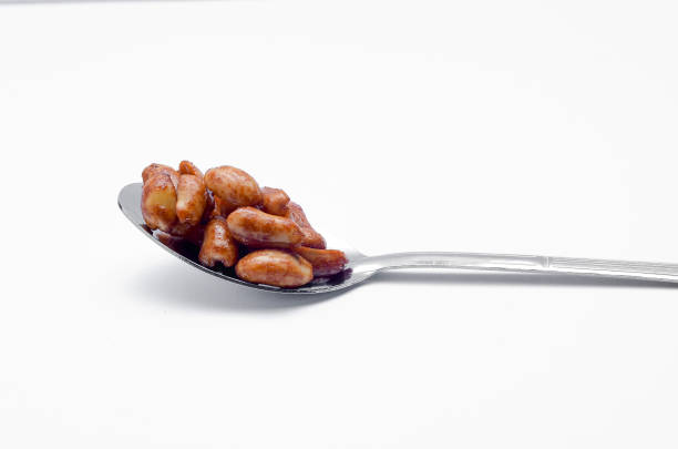 istock Delicious roasted nut in spoon on white background 698594062