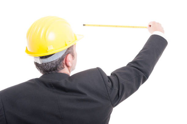 istock Back view of architect posing measuring with ruler tape 698594398