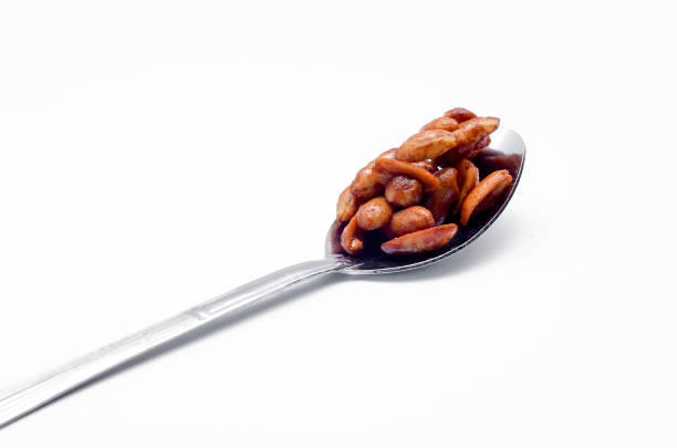 istock Delicious roasted nut in spoon on white background 698594998