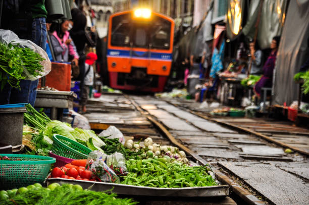 istock Maeklong railway market Bangkok, Thailand. 698595592