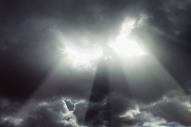 istock Brilliant beams of light break through dark, thundery clouds 698596044