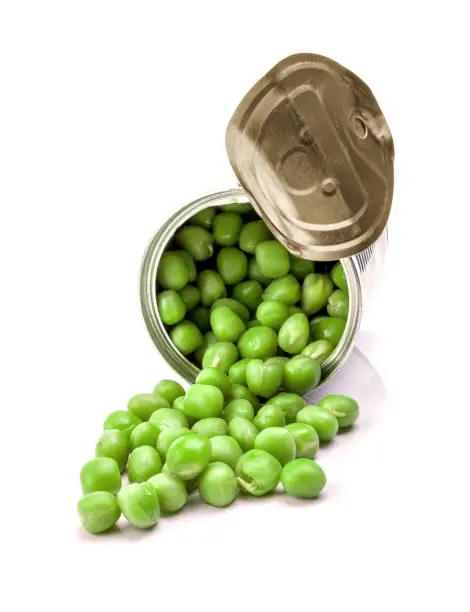 Opened tin with green peas. Isolated on white.