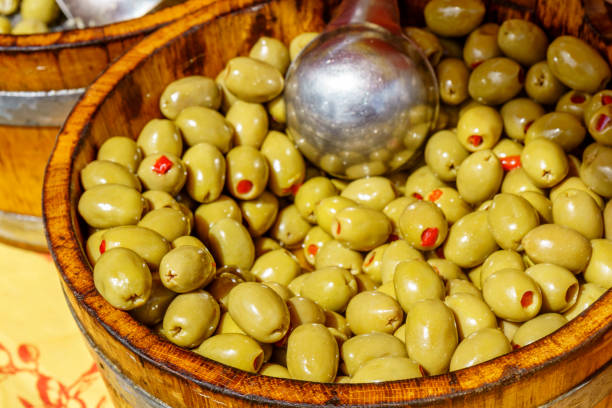 istock Green olives in wooden bowl 698602930