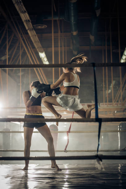 istock Determined female boxers having a fight during a kickboxing match in a ring. 698608868