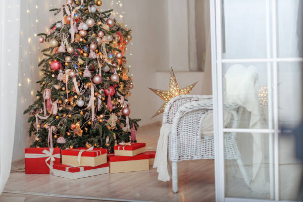 istock Christmas Tree and Christmas gift boxes in the interior with a fireplace. 698614848