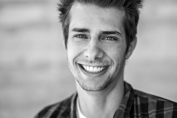 istock smiling young man black&white portrait 698615088
