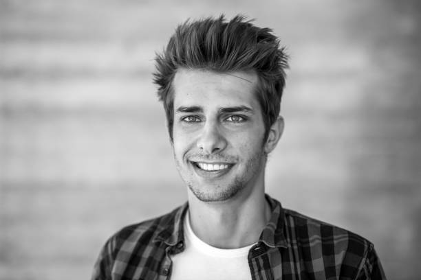 istock smiling young man black&white portrait 698615112