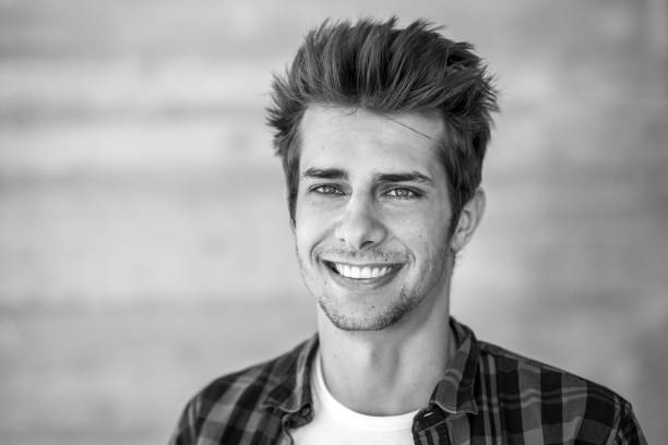 istock smiling young man black&white portrait 698615152