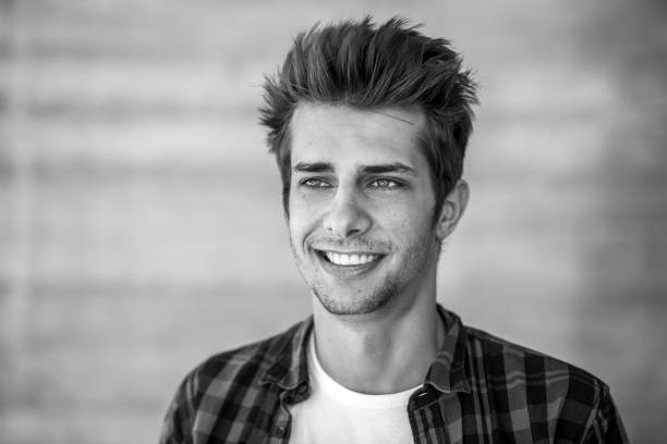 istock smiling young man black&white portrait 698615154