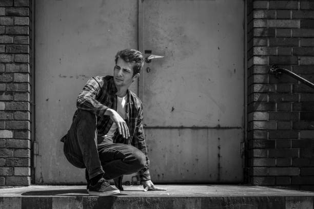 istock young man crouching on ramp of warehouse 698615254