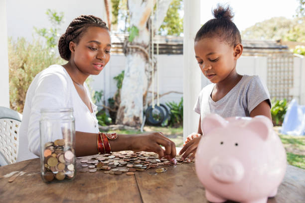 istock Mom counting coins with her daughter. 698615316