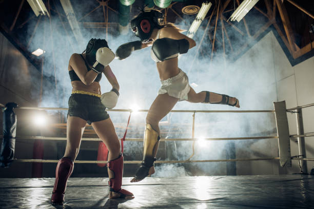 istock Athletic woman making a flying move on a kickboxing match with her sparing partner. 698622022