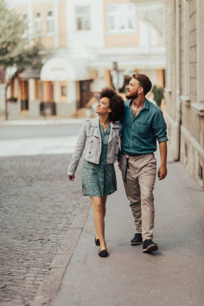 istock Charming couple walking down the street and looking the opposite side 698622830