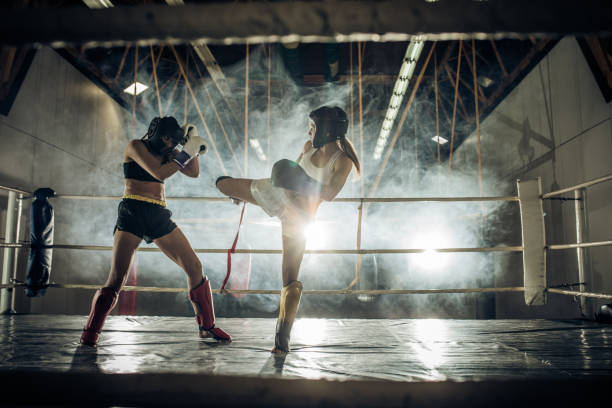 istock Strong women fighting on a kickboxing training in a ring. 698624986