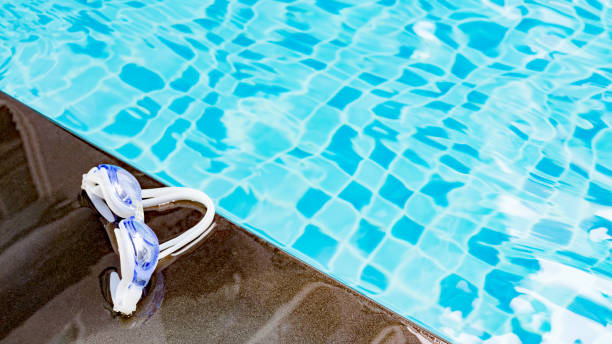 istock Image of swimming pool and goggles with copy space for your text 698628384