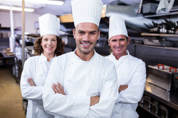 istock Team of chefs standing with arms crossed 698628490