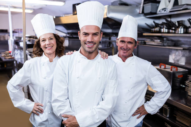 istock Group of happy chefs smiling at the camera 698629368