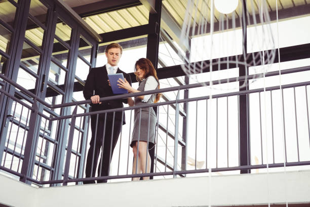 istock Businessman and businesswoman using digital tablet 698635328