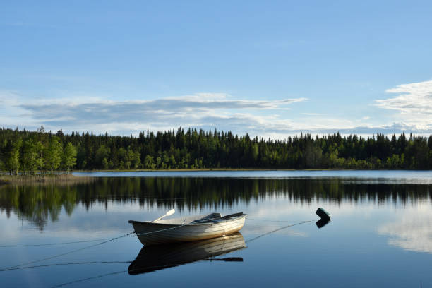 istock Boat moored on a calm lake 698641490